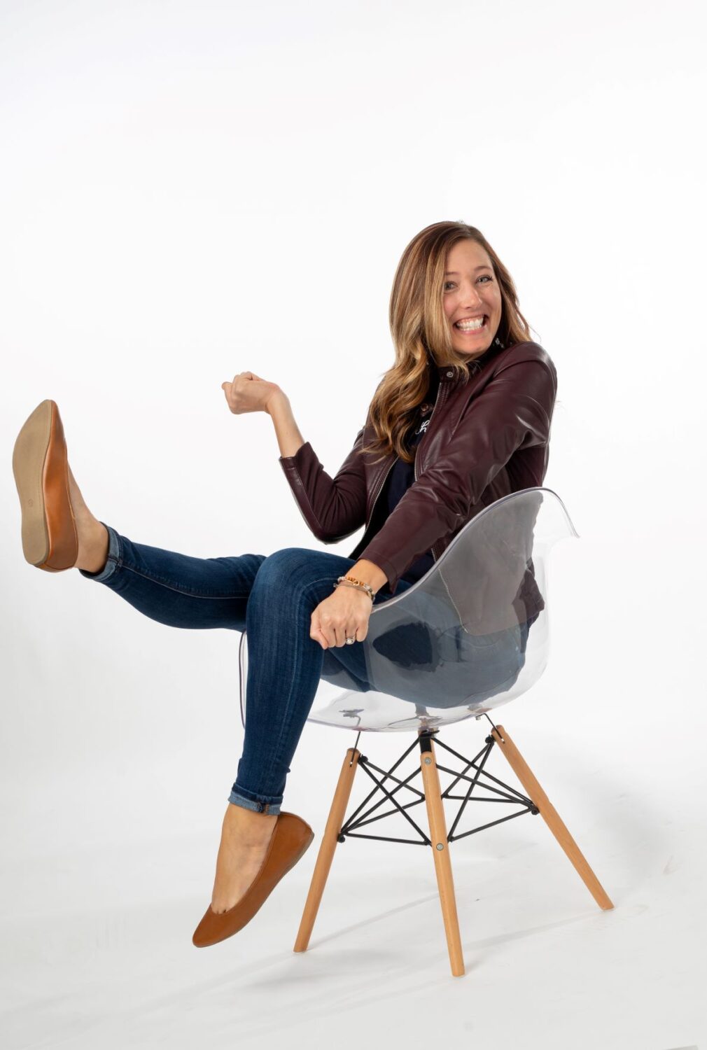 Sarah Watson with happy energy in a chair