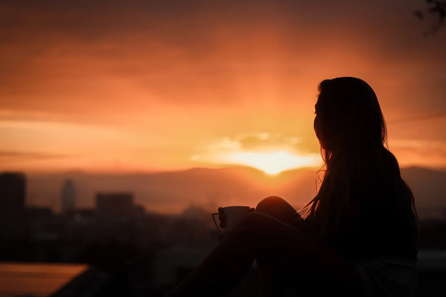 A person looking at a sunset