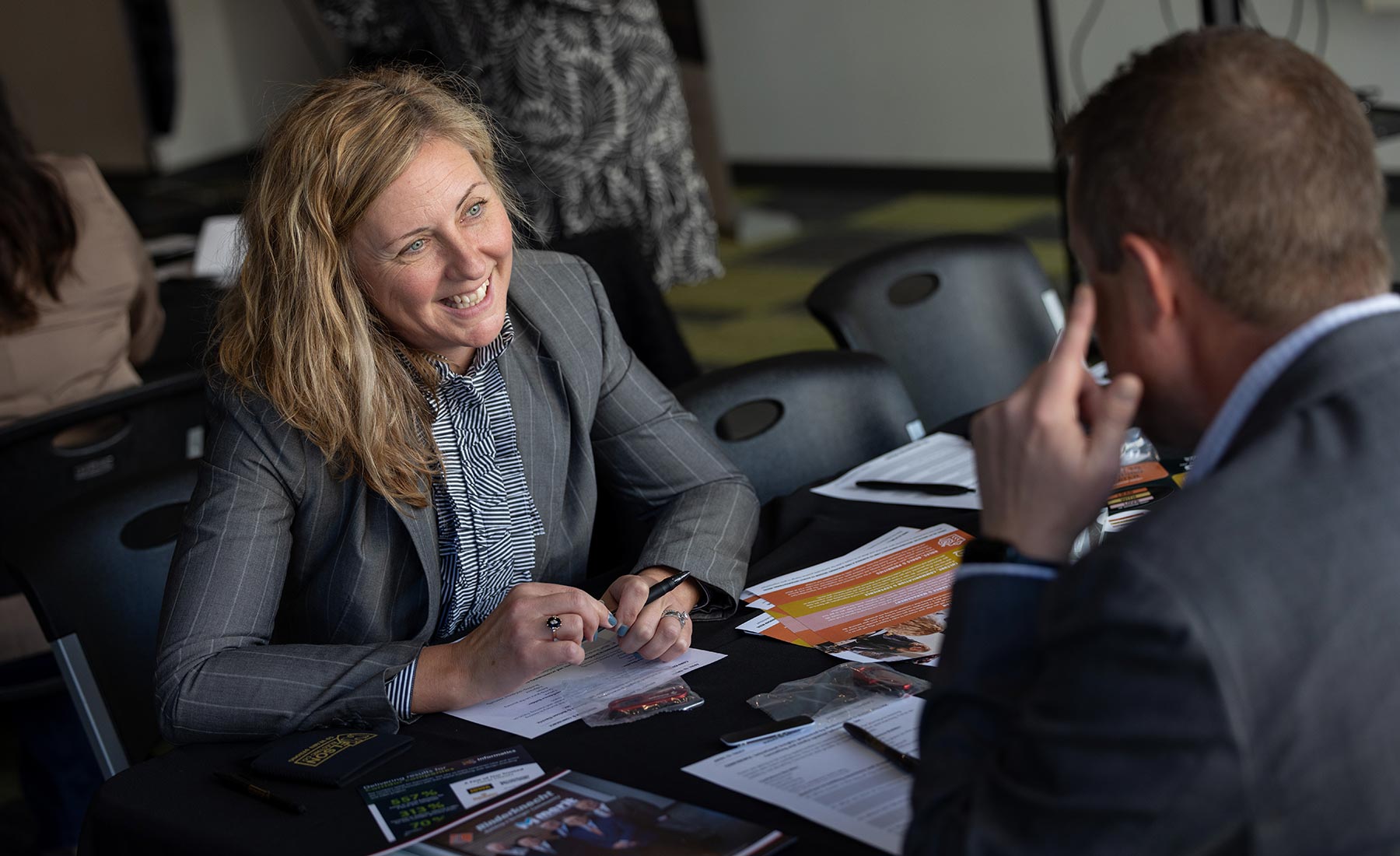 Brooke conducts a meeting with a businessman and both are engaged in conversation