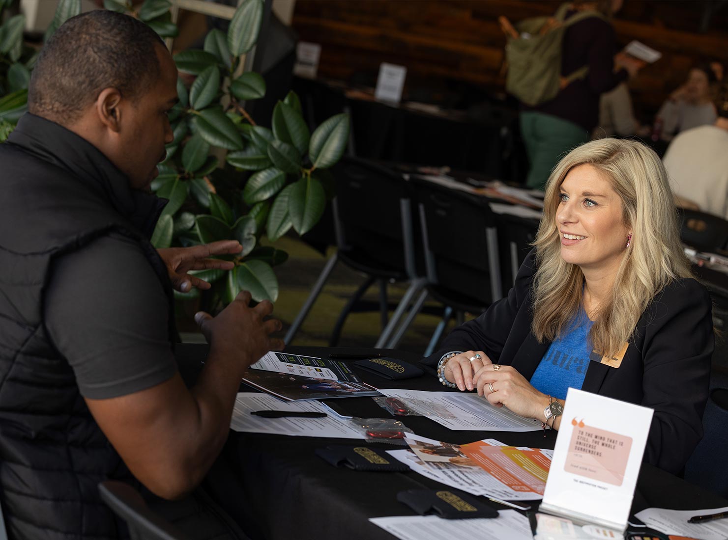 Lindsay works with a client at a table in a workshop setting