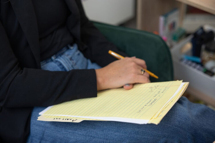 A notepad sits on a lap