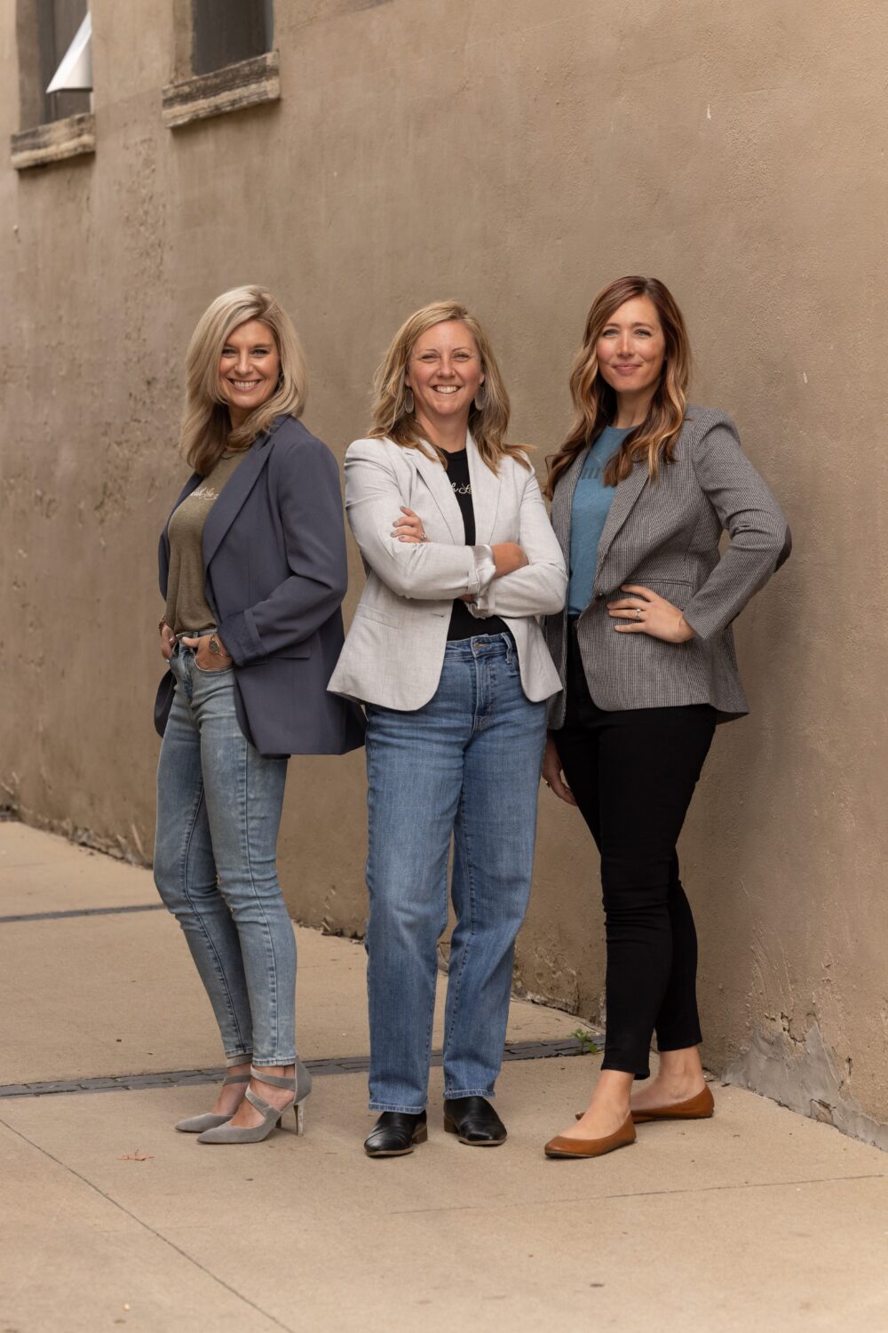 Linsay, Brooke, and Sara stand confidently outside is stylish business casual outfits