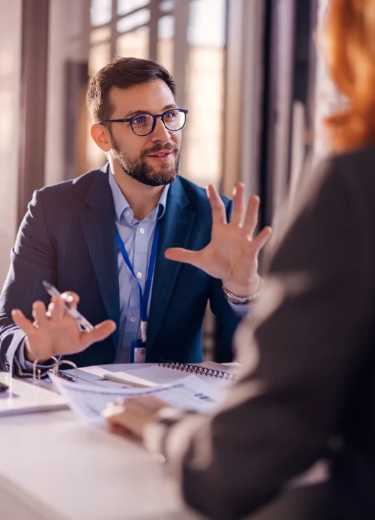 A man works to explain items in a meeting