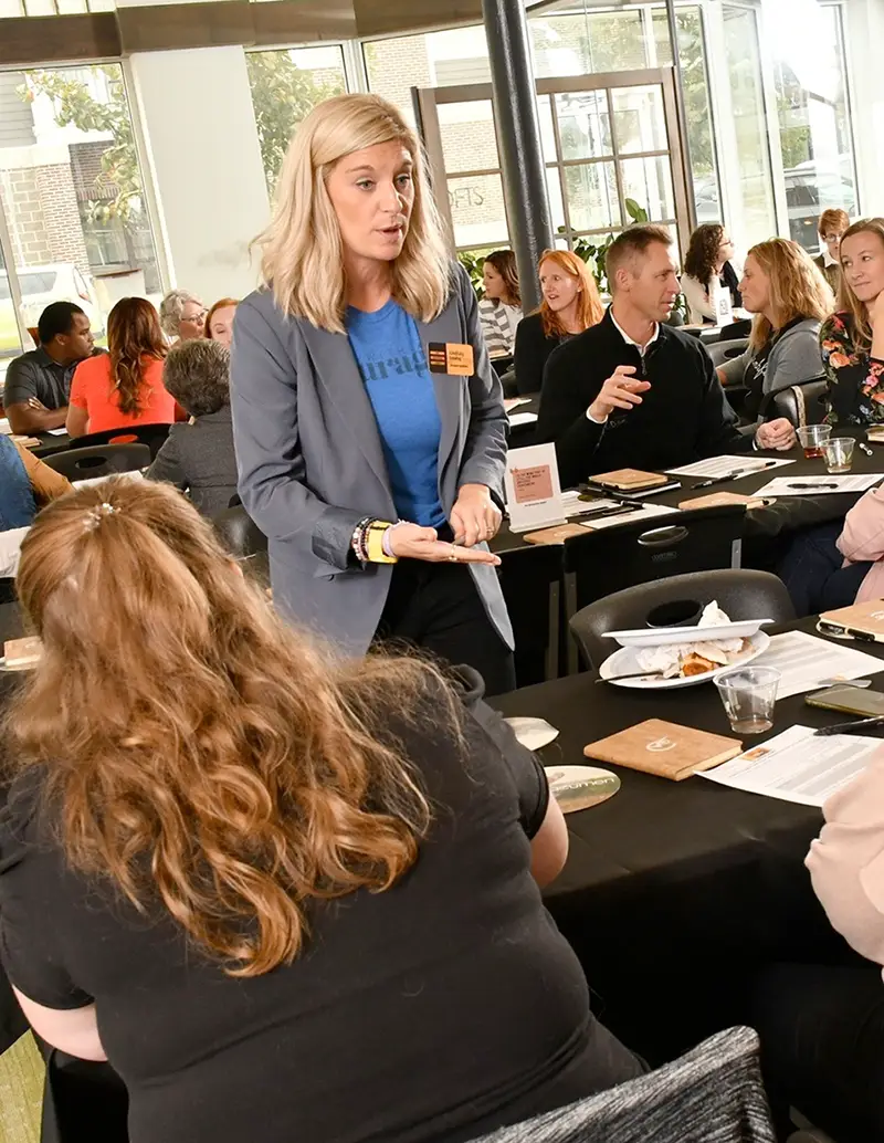 Linsdey leads a course with a full room of people