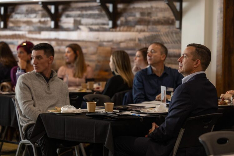 men listening to presenter at an event