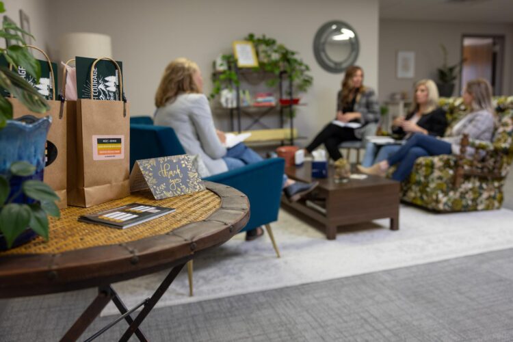 brand merchandise in the foreground and a team having a meeting in the background