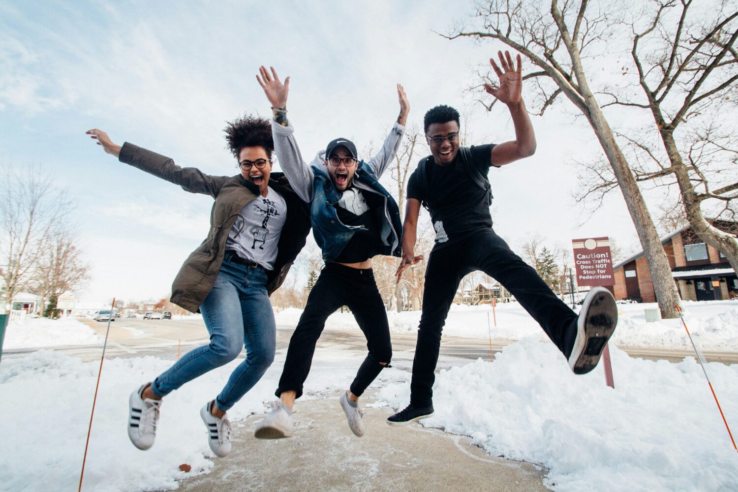 three people celebrating by jumping in the air